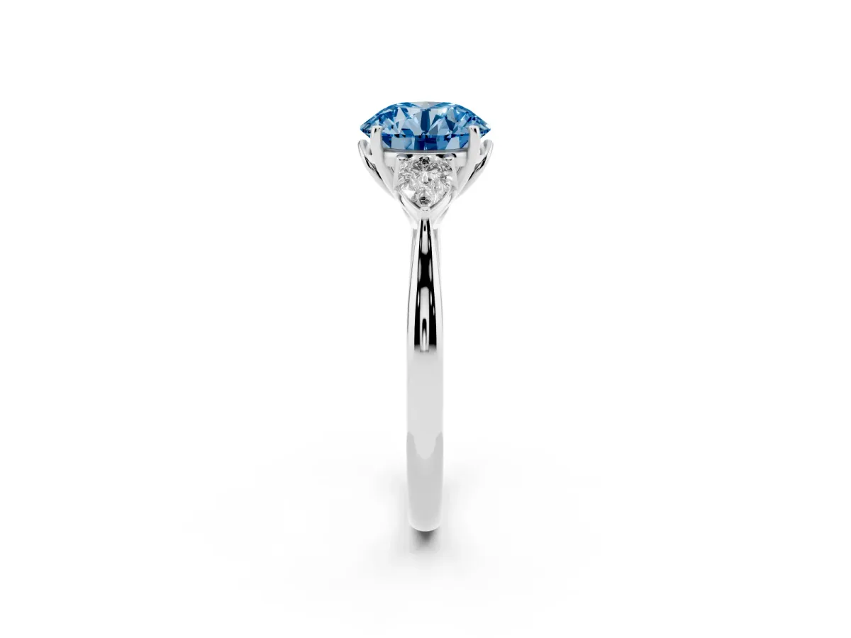 Fancy Blue Three-Stone Round Cut Brilliant Diamond Solitaire Ring with Tapered Band and Four-Prong Setting Platinum