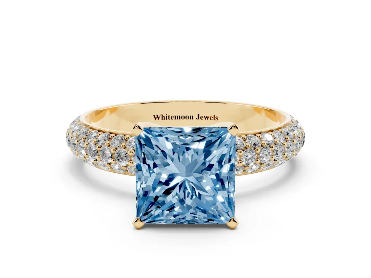 Fancy Blue Princess Cut Diamond Solitaire Ring with Prong Setting and Pavé Band Yellow gold