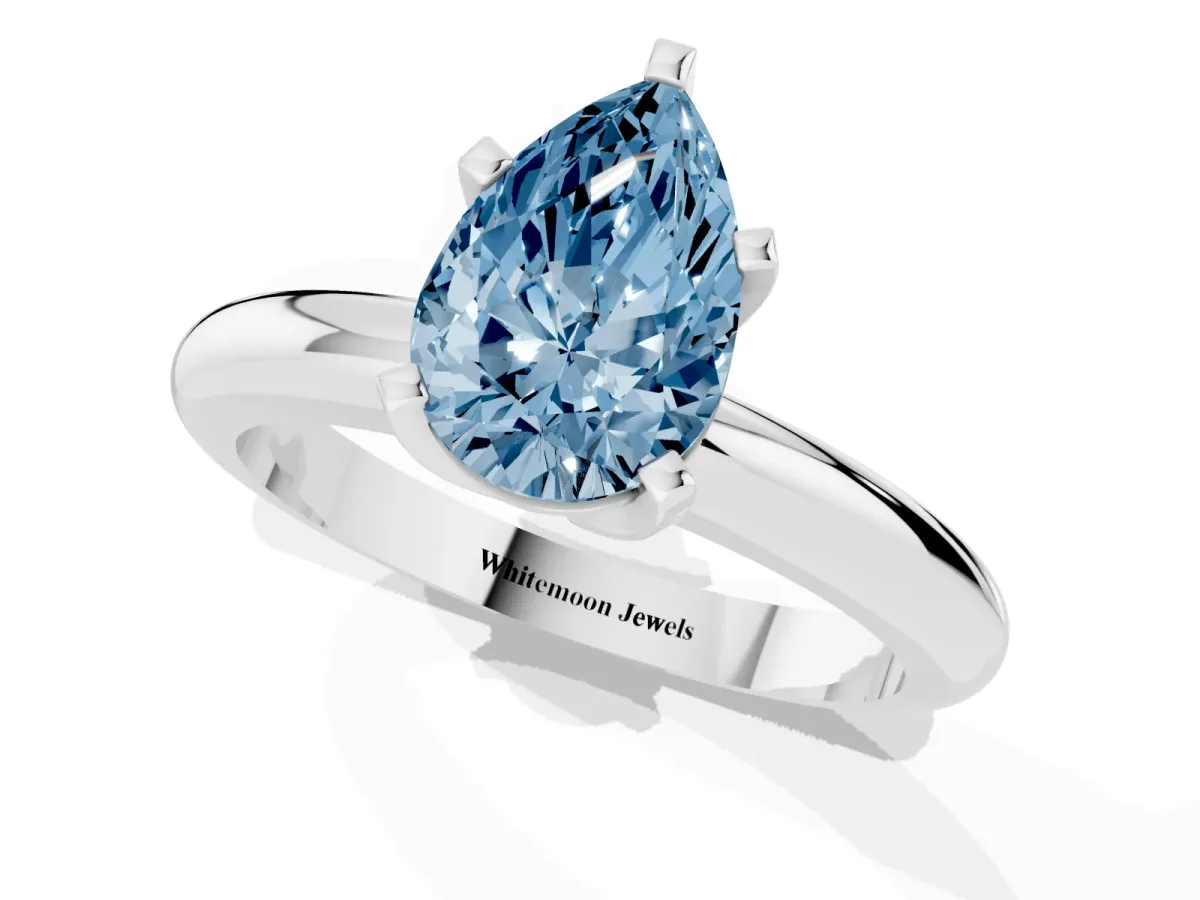 Fancy Blue Pear Cut Diamond Solitaire Engagement Ring with Round Band and Four-Prong Setting Silver