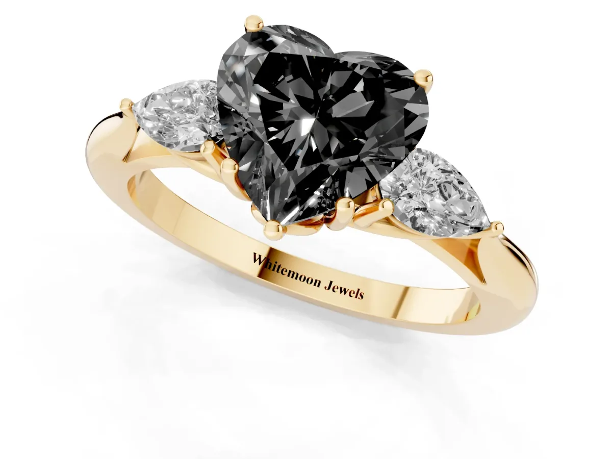 Fancy Black Heart Cut Diamond Three-Stone Ring with Pear Side Stones and Prong Setting Yellow gold