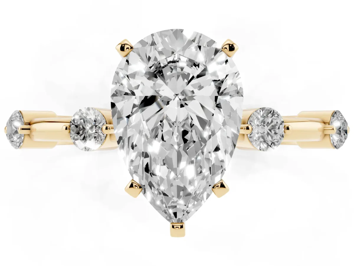 Pear Cut Solitaire Diamond Ring with Bezel Set Side Stones and Prong Setting Yellow gold