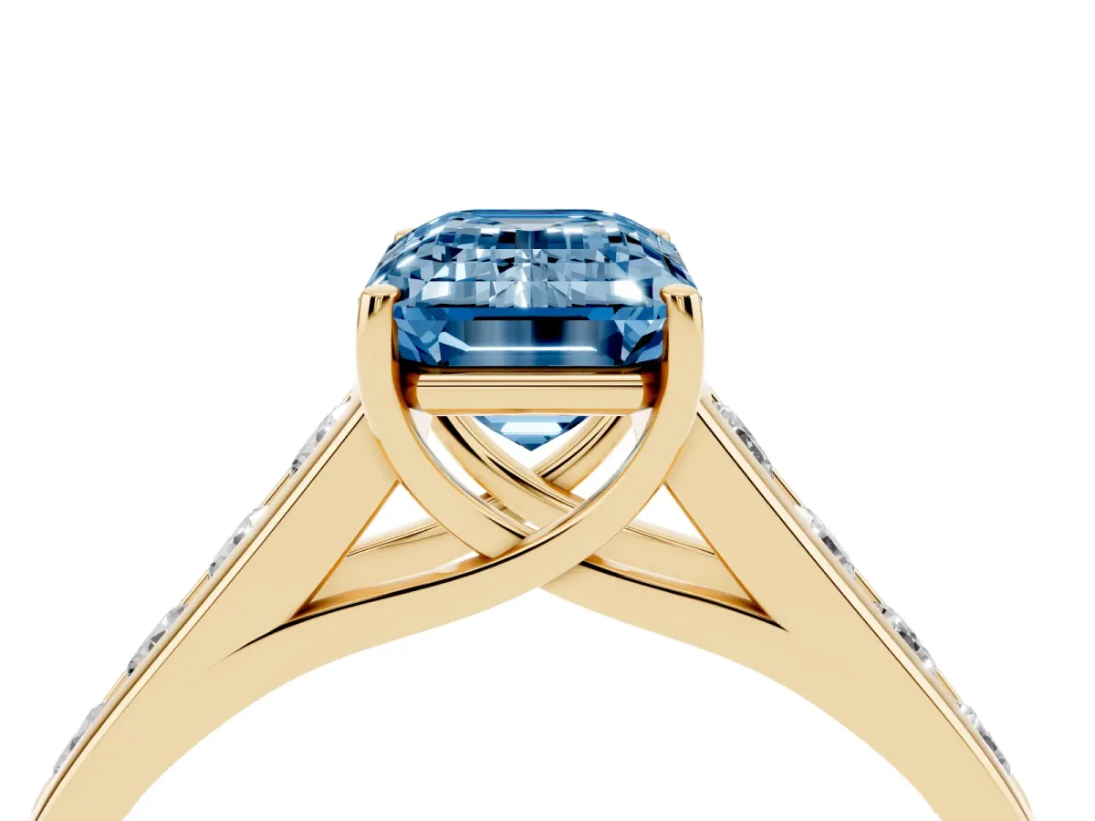 Fancy Blue Emerald Cut Brilliant Channel-Set Solitaire Ring with Four-Prong Setting Yellow gold