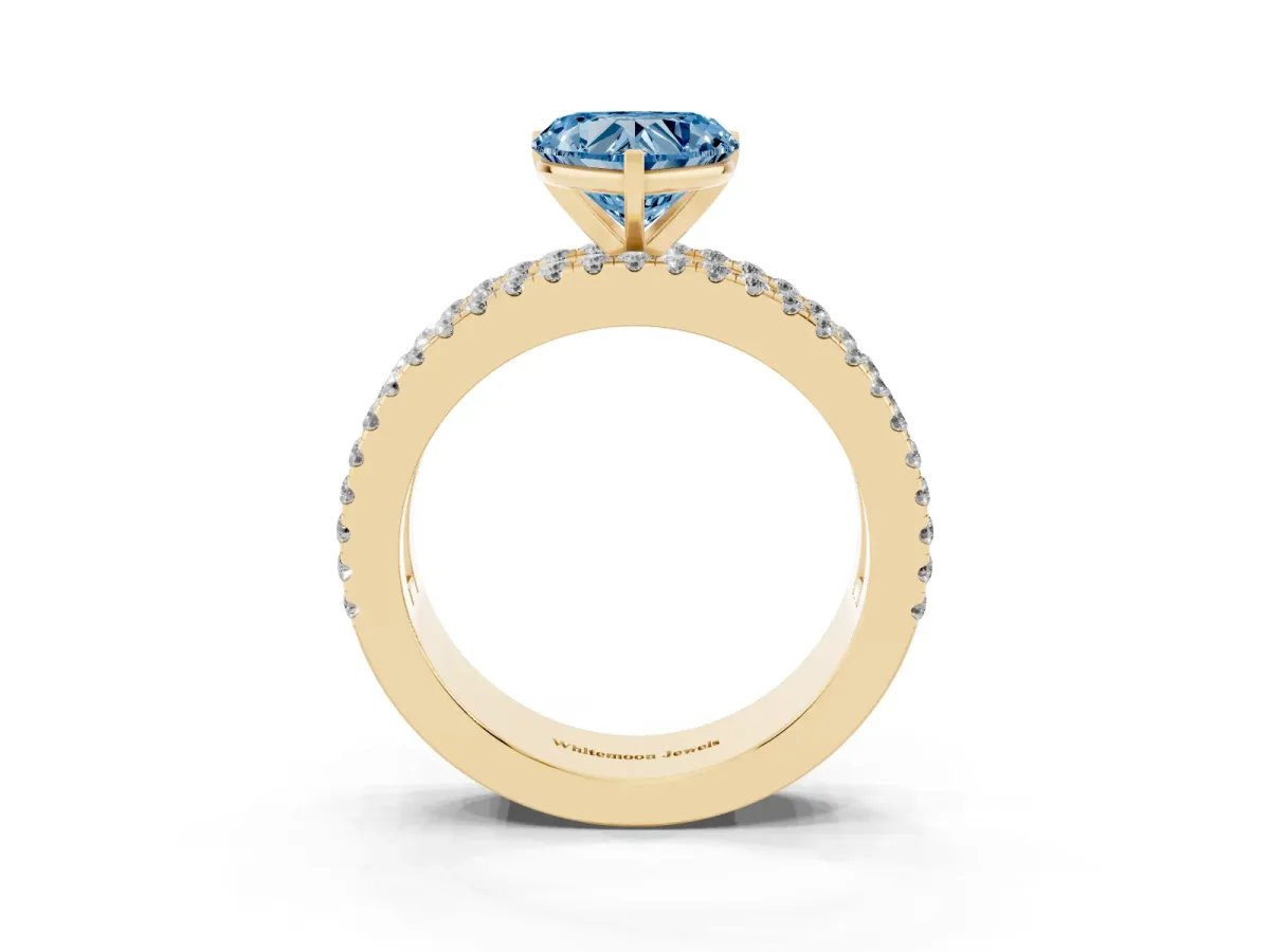 Fancy Blue Heart Cut Diamond Solitaire Ring with Pavé and Channel Set Band Yellow gold