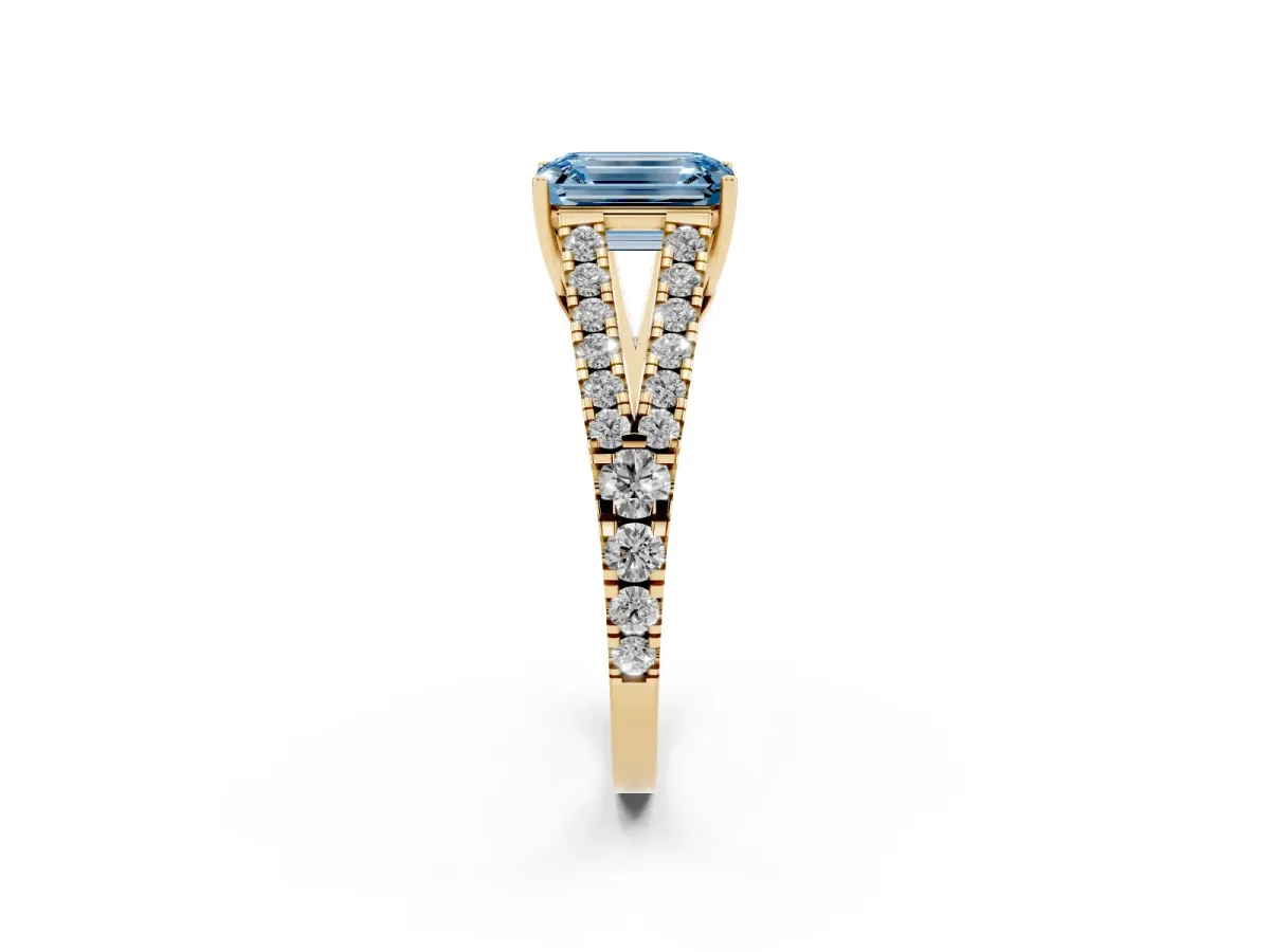 Fancy Blue Emerald Cut Diamond Split Shank Pavé Engagement Ring with Four-Prong Setting Yellow gold