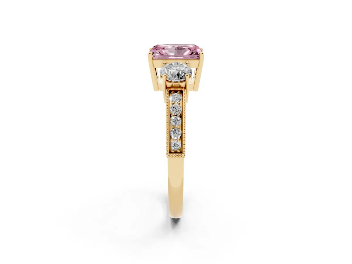Fancy Pink Radiant Cut Three-Stone Diamond Ring with Pavé Band and Four-Prong Setting Yellow gold