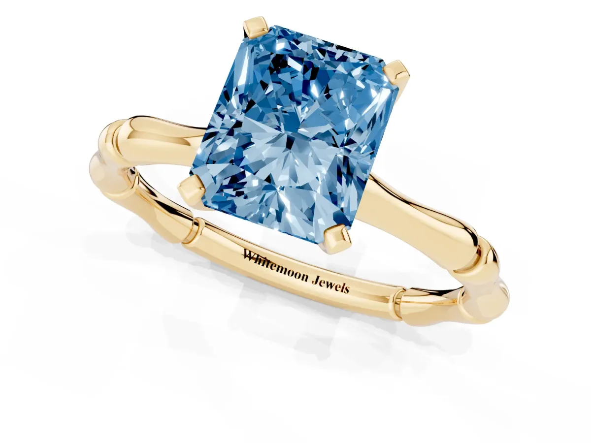 Fancy Blue Radiant Cut Solitaire Diamond Ring with Bamboo Band and Four-Prong Setting Yellow gold