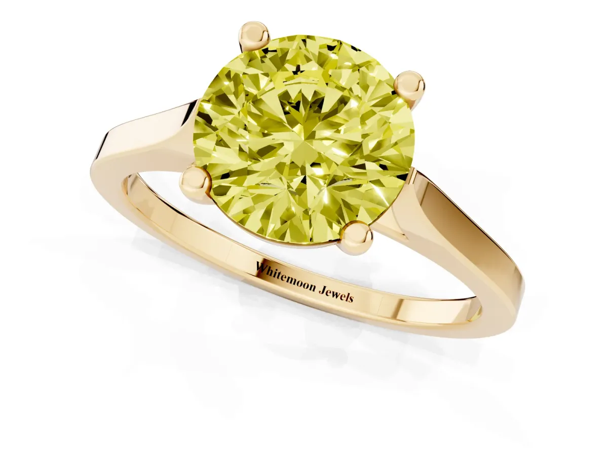 Fancy Yellow Round Cut Solitaire Diamond Ring with Four-Prong Setting and Tapered Band Yellow gold