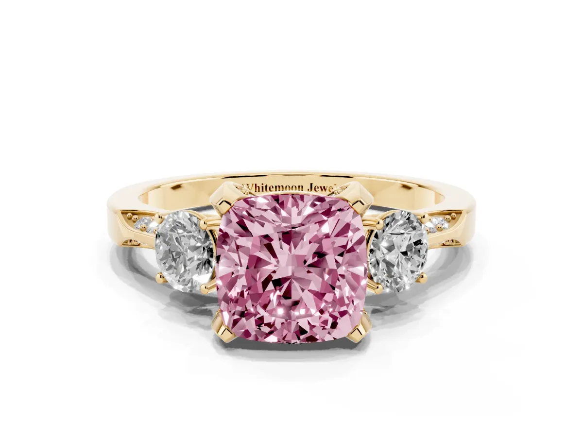 Fancy Pink Cushion Cut Brilliant Three-Stone Diamond Ring with Pavé Band and Four-Prong Setting Yellow gold