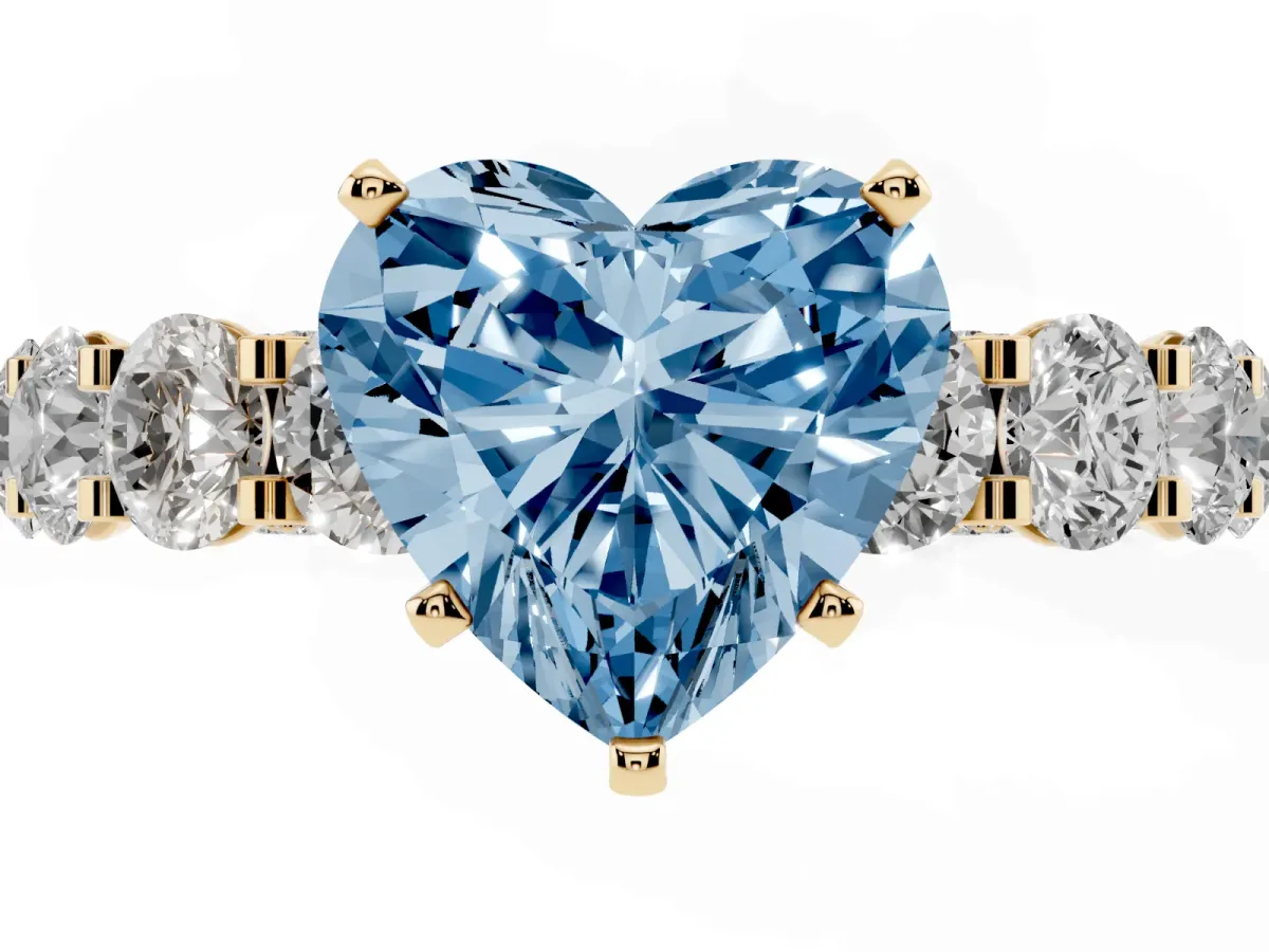 Fancy Blue Heart Cut Diamond Side Stone Engagement Ring with Four-Prong Setting Yellow gold