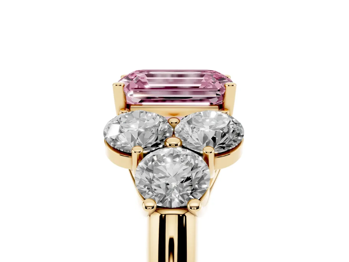 Fancy Pink Emerald Cut Cut Diamond Cluster Ring with Round Accent Stones and Prong Setting on a Classic Band Yellow gold