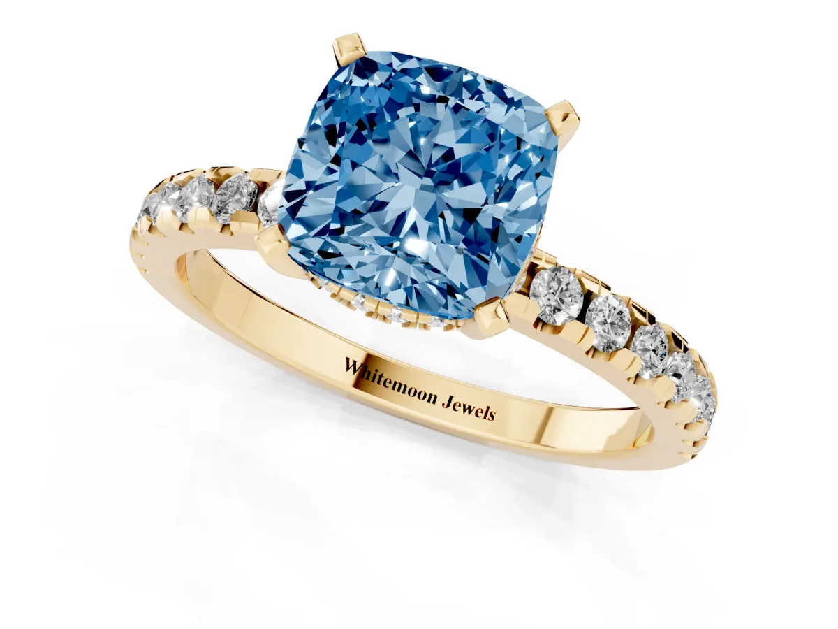 Fancy Blue Cushion Cut Diamond Solitaire Ring with Round Pavé Band and Four-Prong Setting Yellow gold