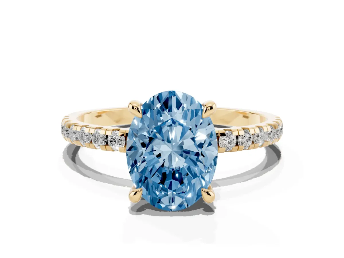 Fancy Blue Oval Cut Diamond Brilliant Solitaire Ring with Pavé Band and Four-Prong Setting Yellow gold