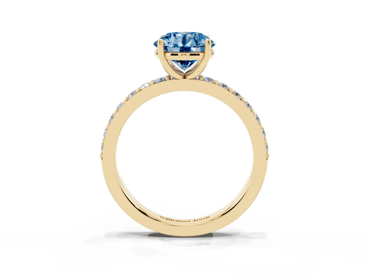 Fancy Blue Round Cut Cut Diamond Solitaire with Pave Band and Four-Prong Setting Yellow gold