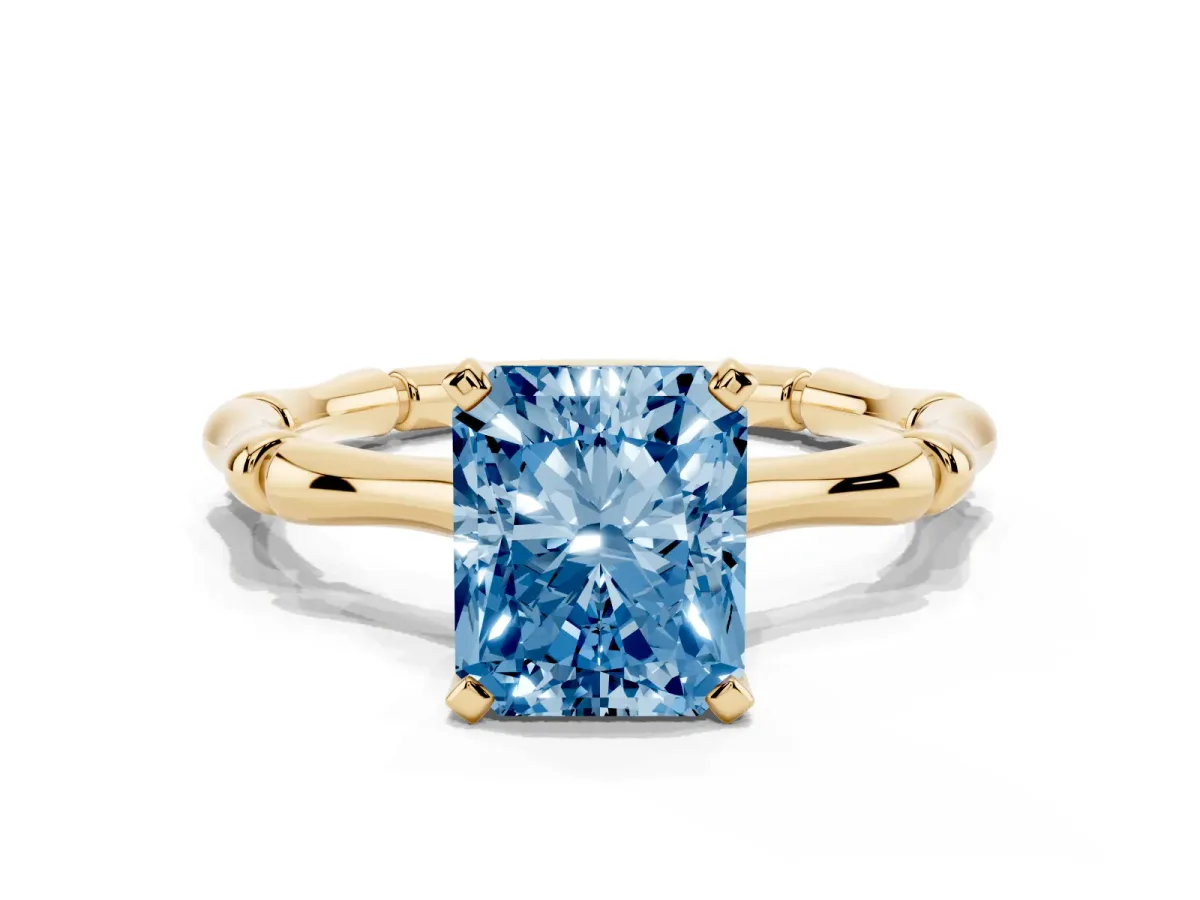 Fancy Blue Radiant Cut Solitaire Diamond Ring with Bamboo Band and Four-Prong Setting Yellow gold