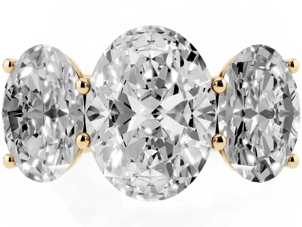 Oval Cut Three-Stone Diamond Ring with Prong Setting on a Classic Band Yellow gold
