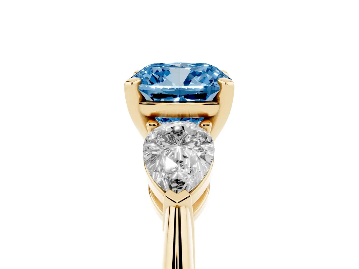 Fancy Blue Three-Stone Cushion Cut Diamond Ring with Pear Side Stones and Four-Prong Setting Yellow gold