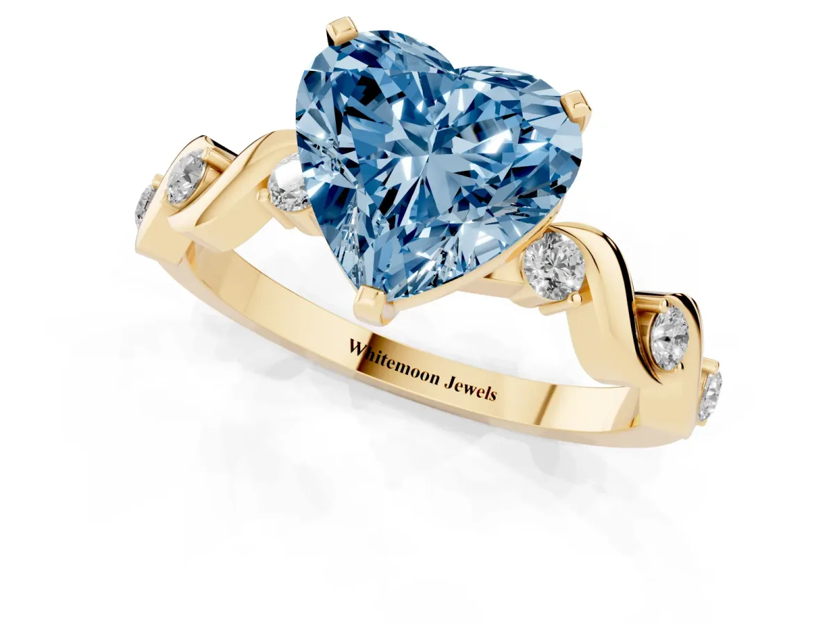 Fancy Blue Heart Cut Diamond Solitaire Twisted Band with Round Accents and Prong Setting Yellow gold