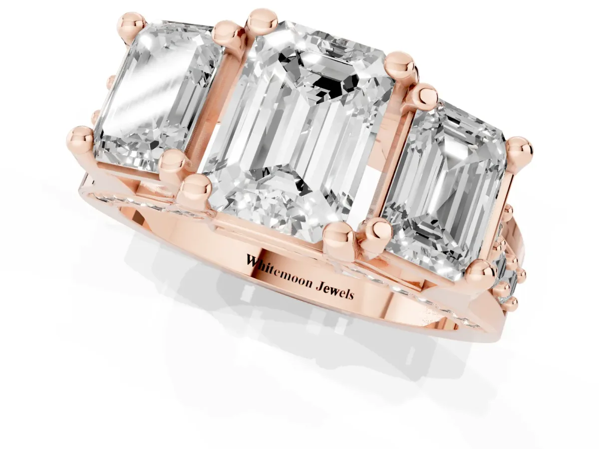 Emerald Cut Diamond Three-Stone Ring with Channel Set Band and Four-Prong Setting Rose gold