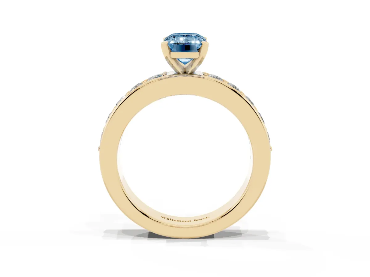 Fancy Blue Emerald Cut Diamond Engagement Ring with Channel Set Round Band and Prong Setting Yellow gold