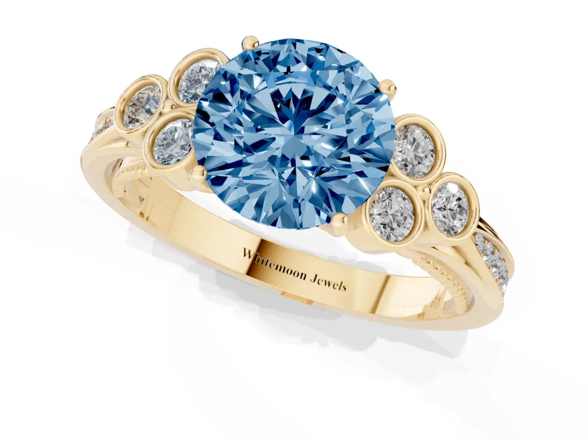 Fancy Blue Round Cut Cut Diamond Engagement Ring with Bezel Set Round Side Stones and Prong Setting Yellow gold