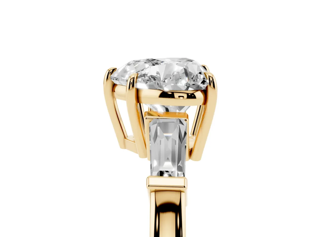 Heart Cut Diamond Three-Stone Ring with Tapered Baguette Side Stones and Prong Setting Yellow gold
