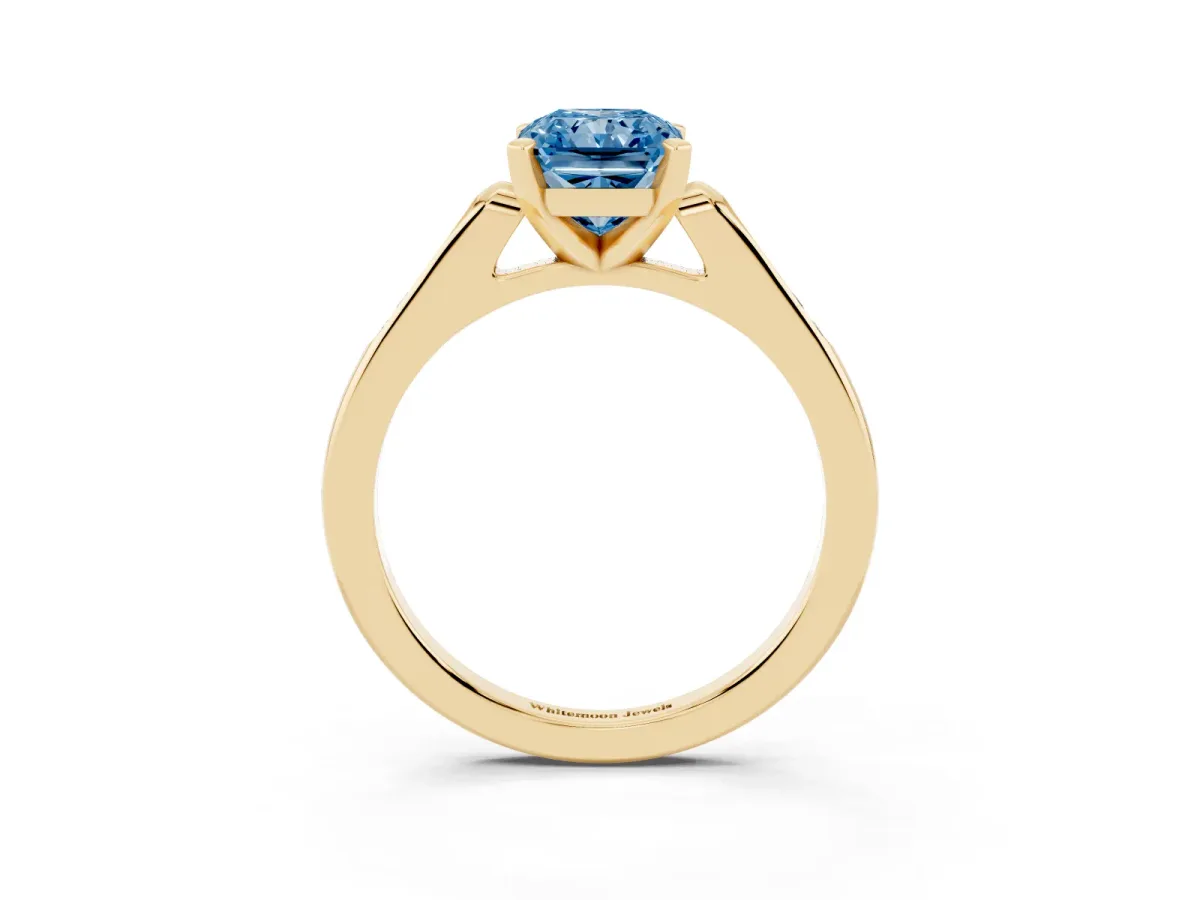 Fancy Blue Radiant Cut Diamond Solitaire Ring with Channel Set Round Band and Prong Setting Yellow gold