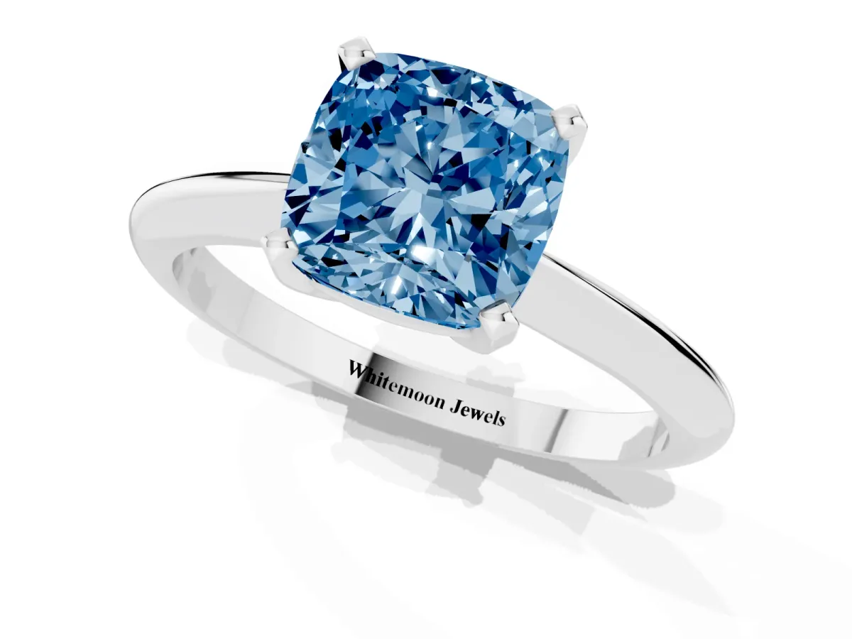 Fancy Blue Cushion Cut Cut Solitaire Ring with Four-Prong Setting on a Classic Band Silver