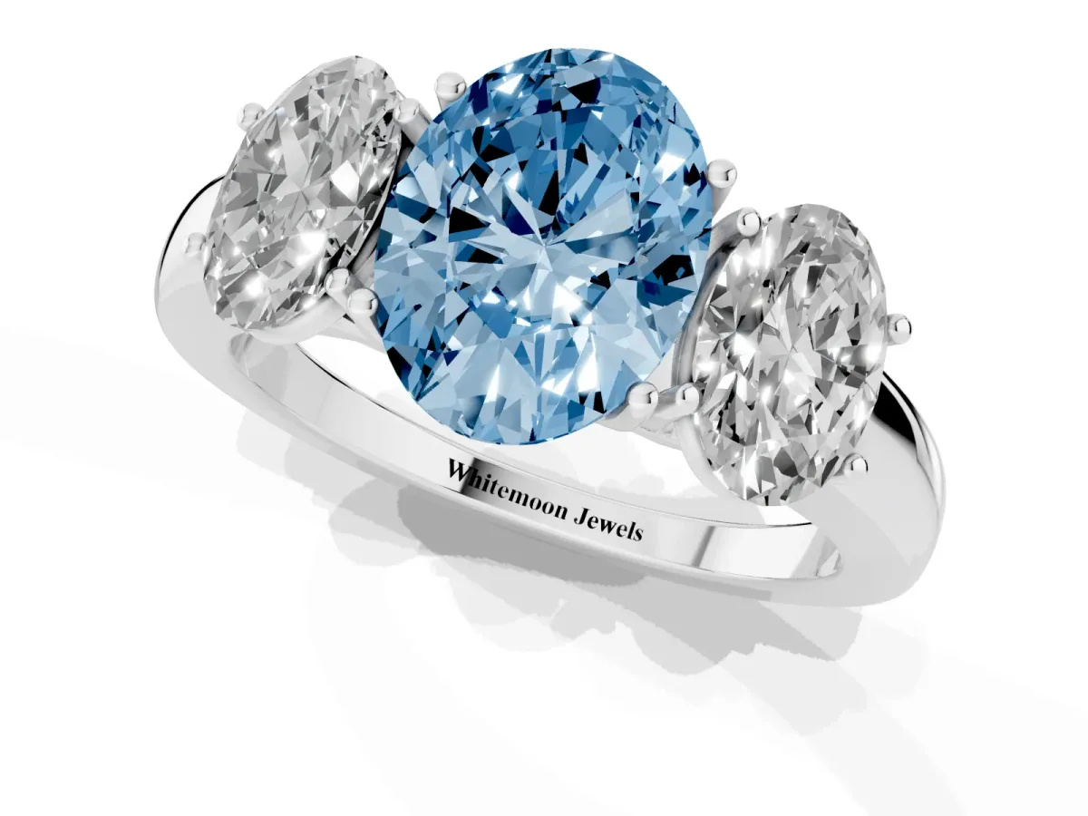 Fancy Blue Oval Cut Diamond Three-Stone Ring with Four-Prong Setting and Classic Band Platinum