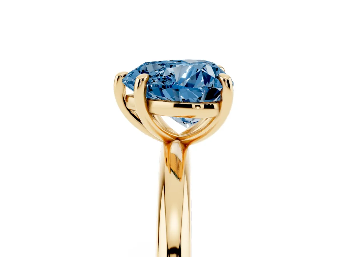 Fancy Blue Heart Cut Solitaire Diamond Ring with Four-Prong Setting on a Plain Band Yellow gold