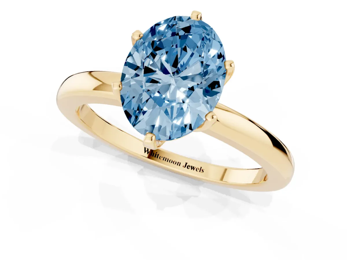 Fancy Blue Oval Cut Solitaire Diamond Ring with Six-Prong Setting on a Classic Band Yellow gold