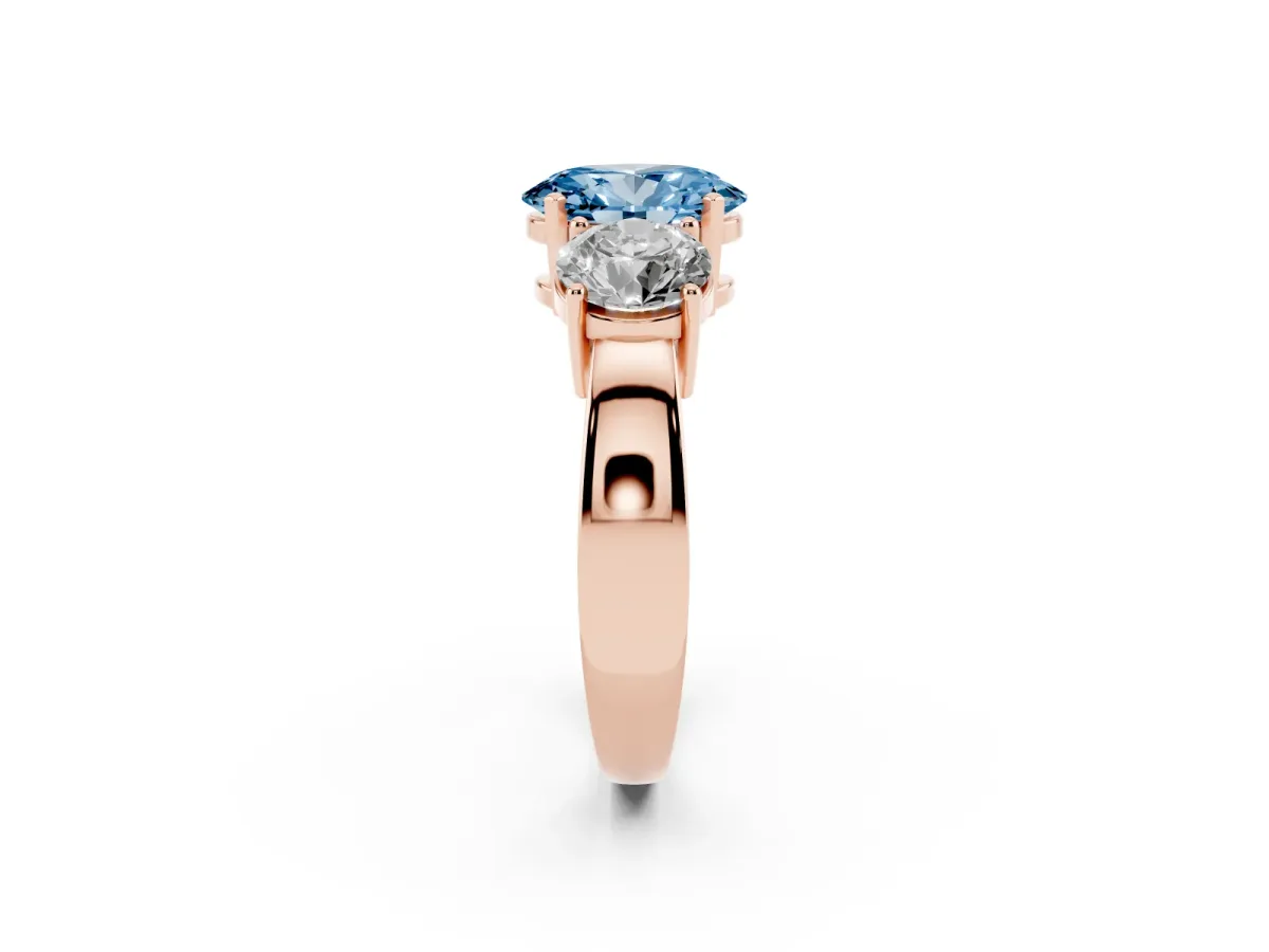 Fancy Blue Three-Stone Oval Cut Diamond Ring with Round Side Stones, Classic Band, and Four-Prong Setting Rose gold