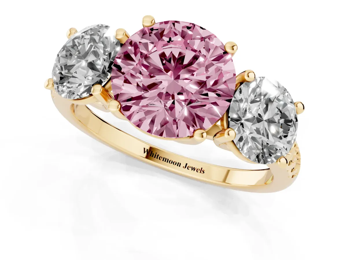 Fancy Pink Three-Stone Round Cut Diamond Ring with Round Pavé Band and Prong Setting Yellow gold