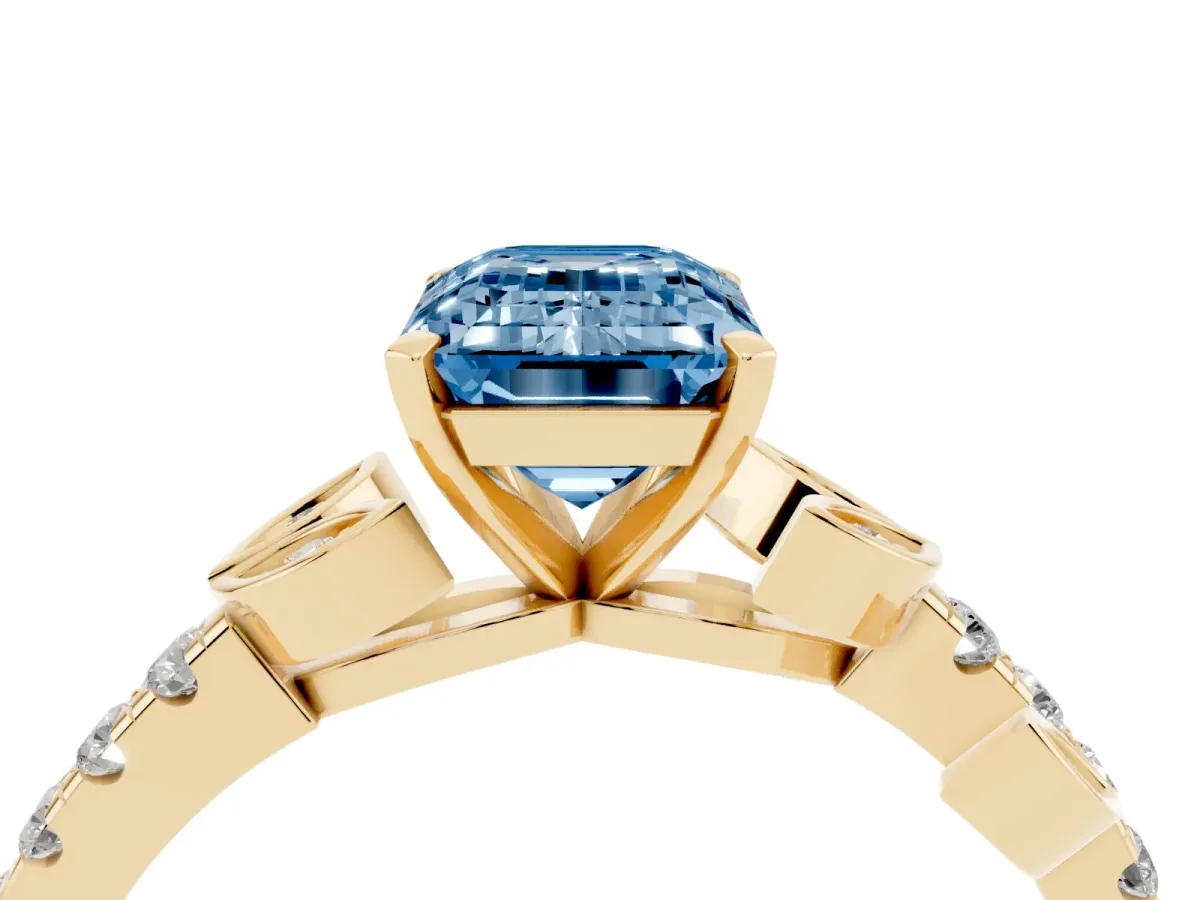 Fancy Blue Emerald Cut Solitaire Leaf-Inspired Diamond Ring with Pavé Band and Four-Prong Setting Yellow gold