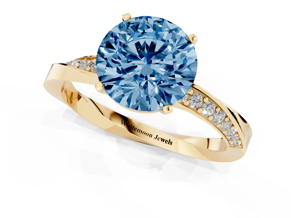 Fancy Blue Round Cut Diamond Engagement Ring with Side Stone Accents and Four-Prong Setting Yellow gold
