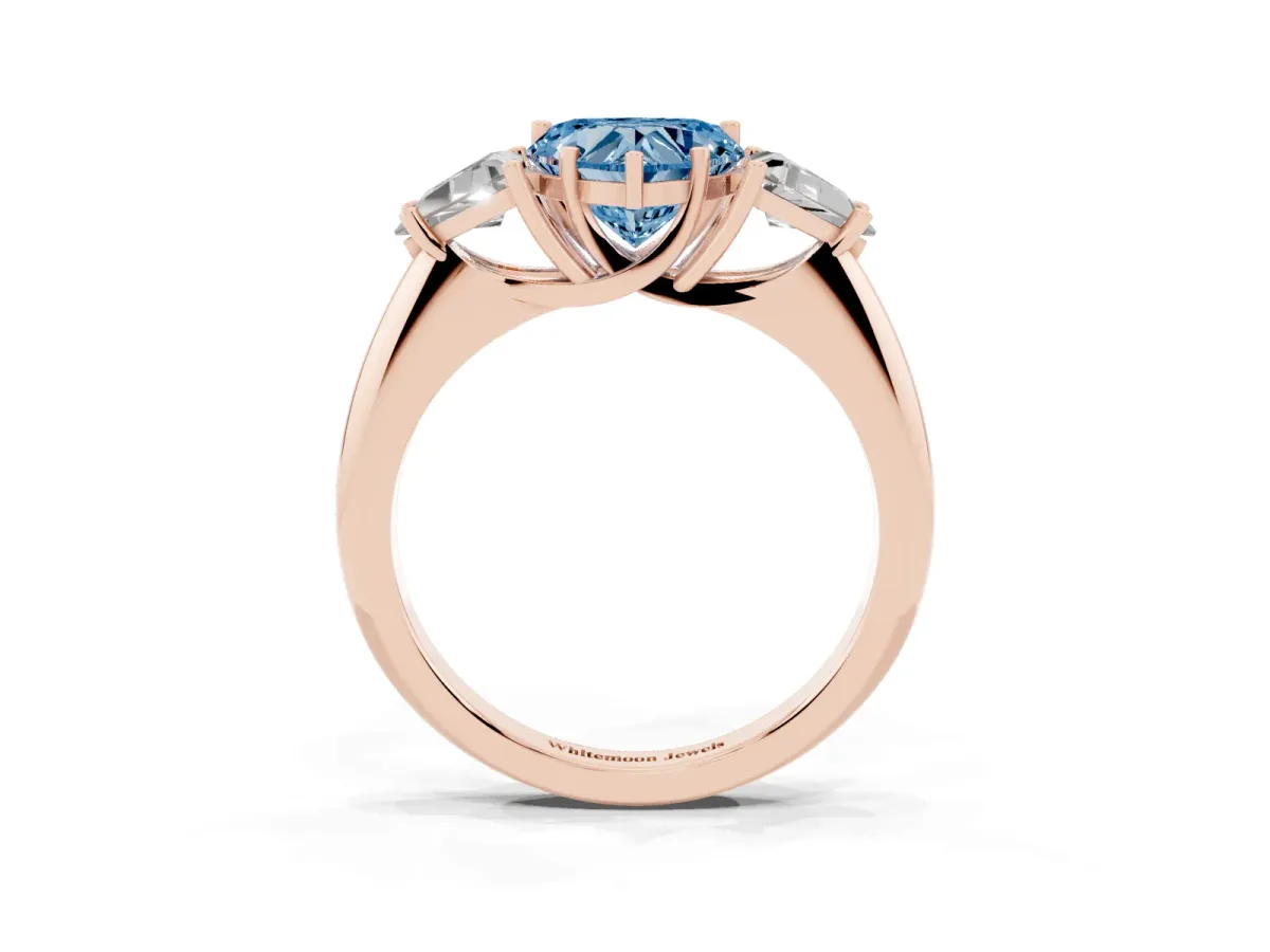 Fancy Blue Three-Stone Heart Cut Diamond Engagement Ring with Trillion Side Stones and Prong Setting Rose gold