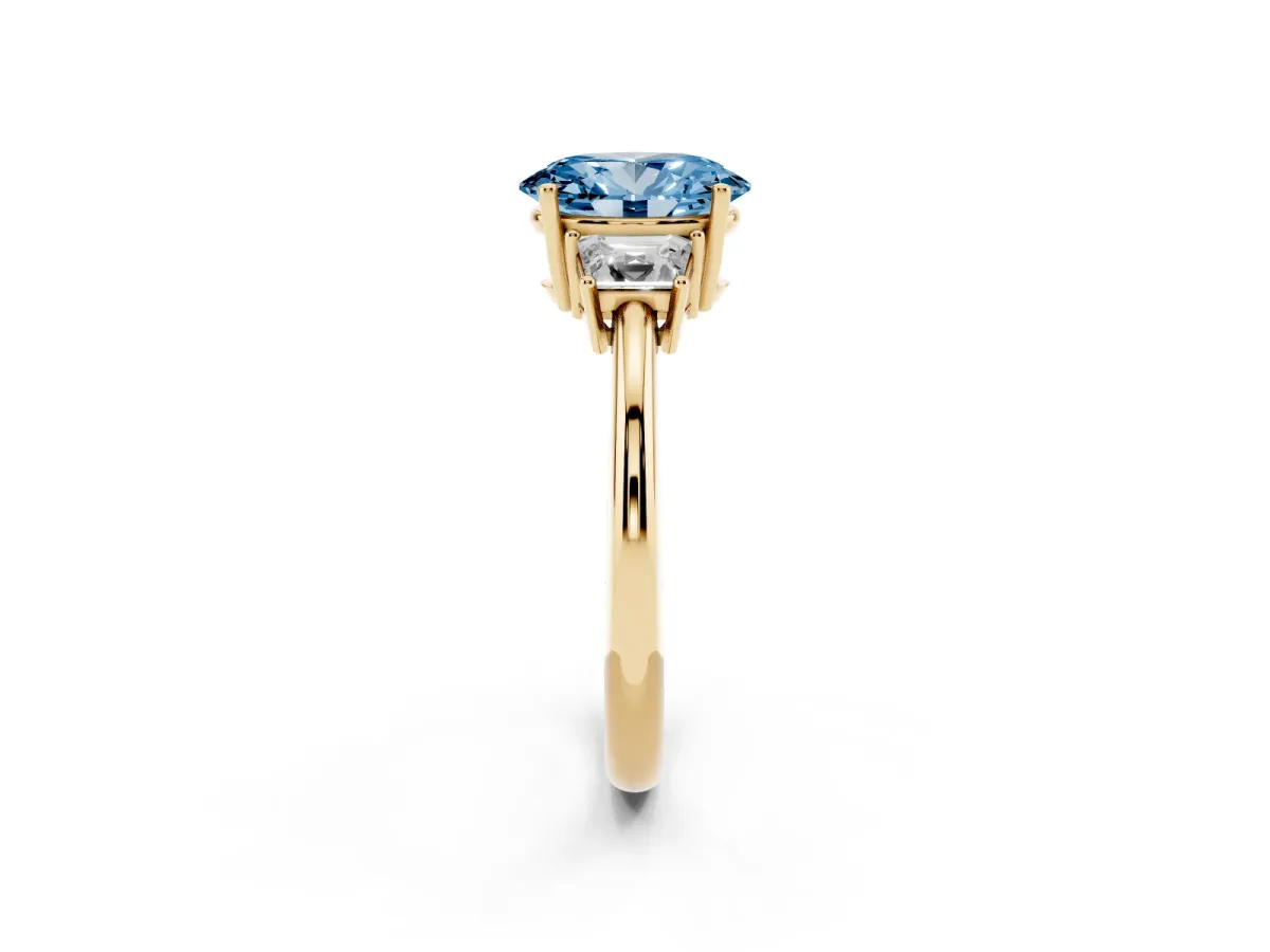 Fancy Blue Oval Cut Diamond Three-Stone Ring with Trapezoid Side Stones and Prong Setting Yellow gold