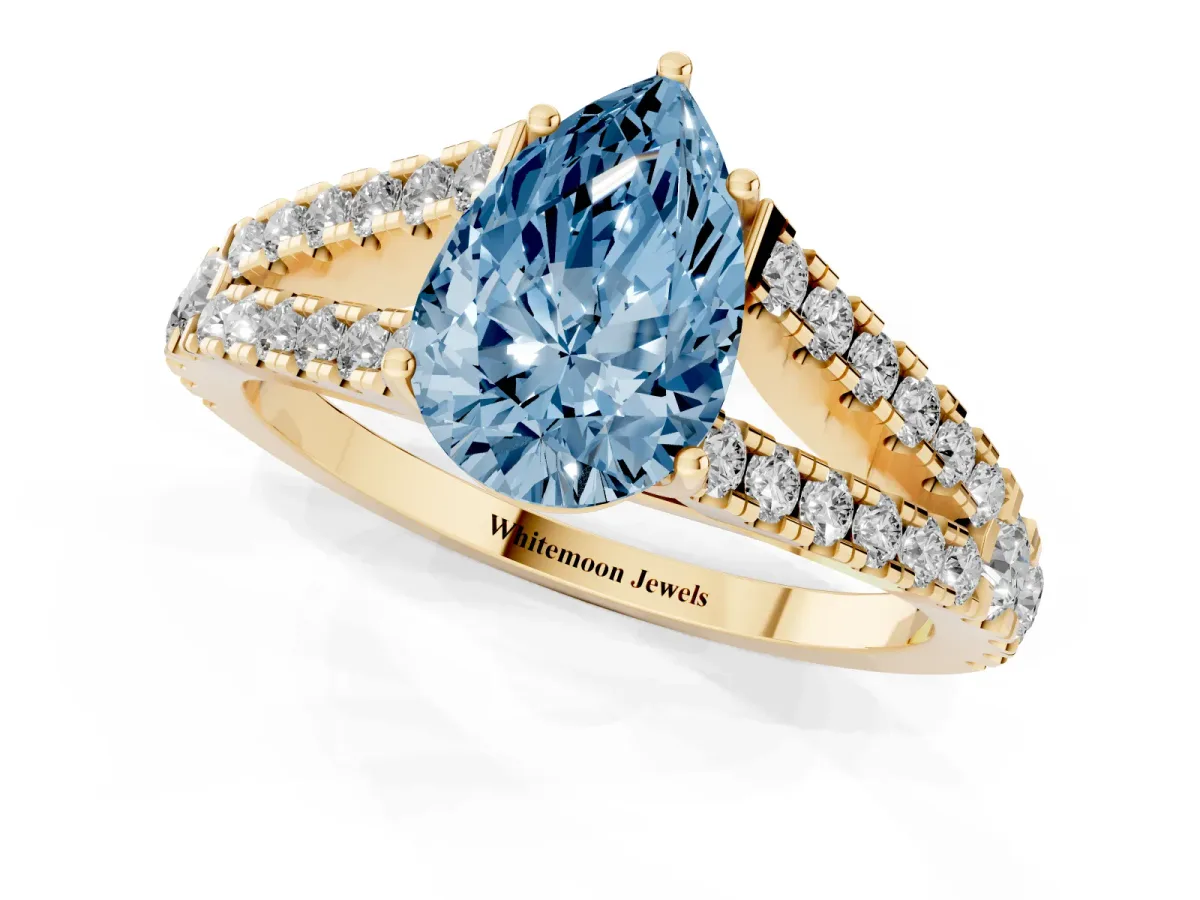 Fancy Blue Pear Cut Diamond Split Shank Pavé Engagement Ring with Four-Prong Setting Yellow gold