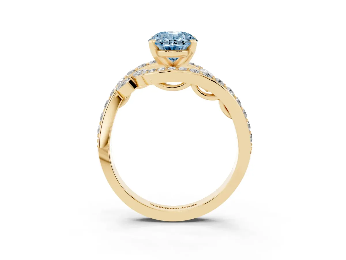 Fancy Blue Oval Cut Solitaire with Pavé Twist Band and Four-Prong Setting Yellow gold