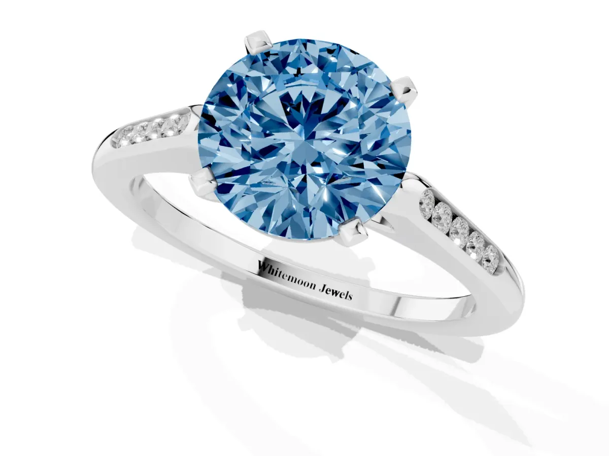 Fancy Blue Round Cut Diamond Solitaire Ring with Channel Set Round Band and Prong Setting Silver
