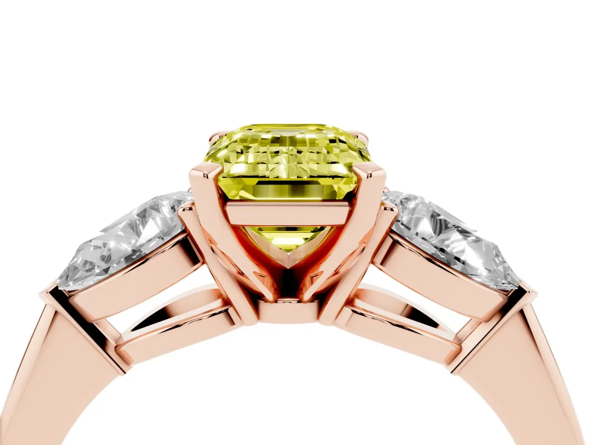 Fancy Yellow Three-Stone Emerald Cut Diamond Ring with Pear Side Stones and Four-Prong Setting Rose gold