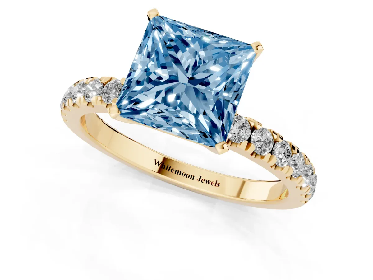 Fancy Blue Princess Cut Diamond Solitaire Ring with Pavé Accents and Four-Prong Setting Yellow gold