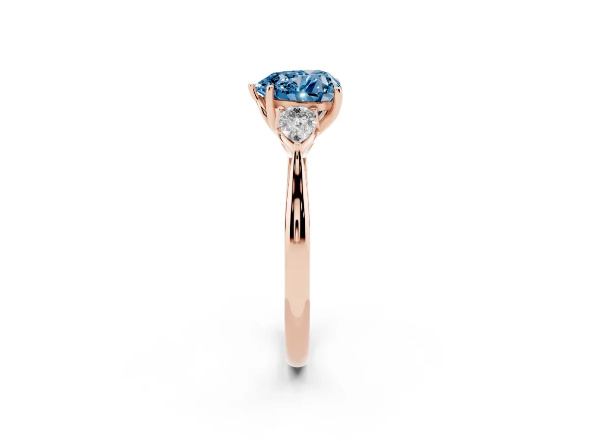 Fancy Blue Heart Cut Diamond Three-Stone Ring with Pear Side Stones and Prong Setting Rose gold