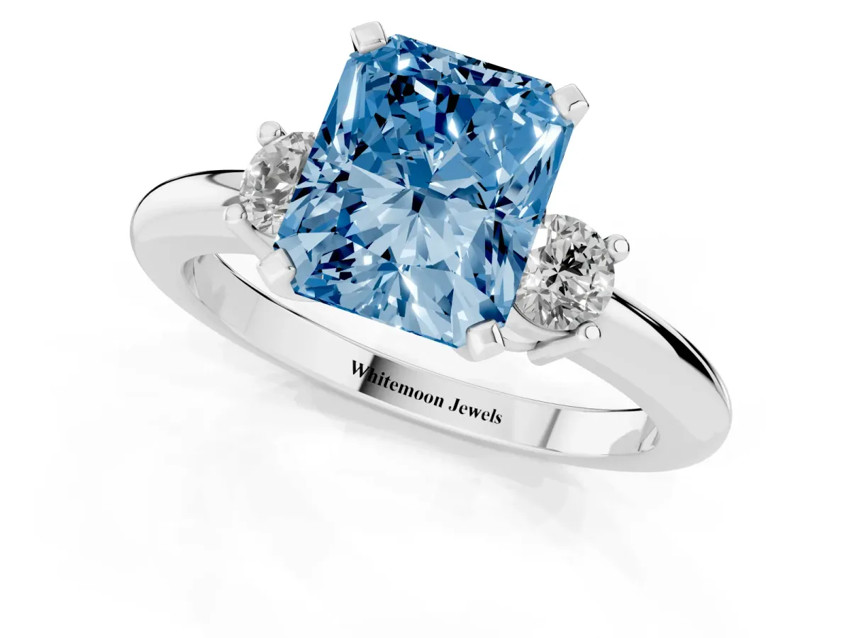 Fancy Blue Three-Stone Radiant Cut Cut Diamond Solitaire with Prong Setting and Classic Band Platinum