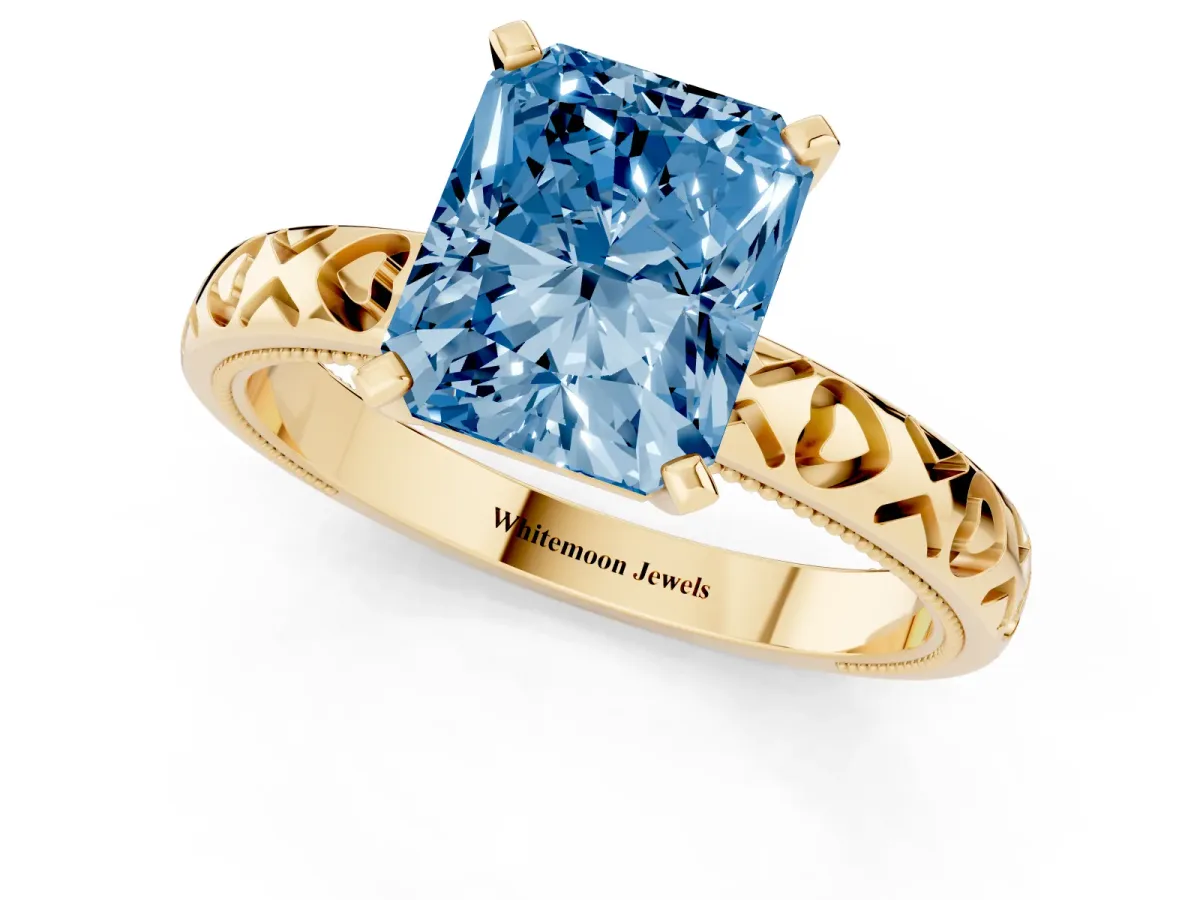 Fancy Blue Radiant Cut Solitaire Diamond Engagement Ring with XO Engraved Band and Four-Prong Setting Yellow gold