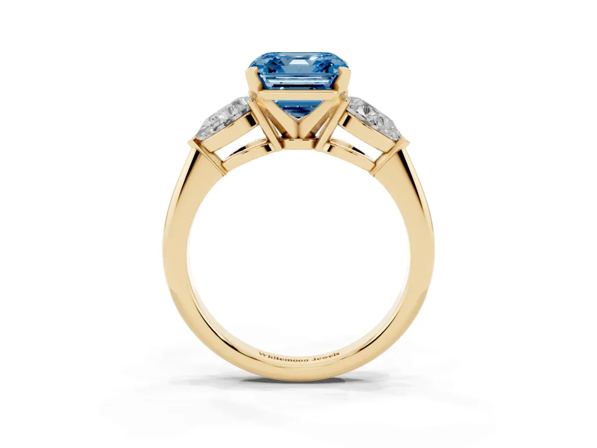 Fancy Blue Three-Stone Asscher Cut Diamond Ring with Pear Side Stones and Four-Prong Setting Yellow gold