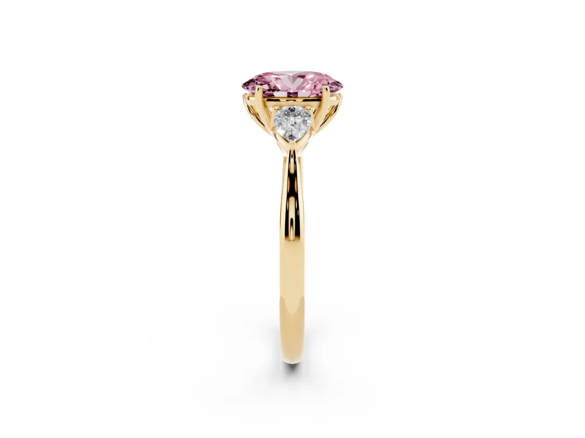 Fancy Pink Three-Stone Oval Cut Diamond Ring with Pear Side Stones in Four-Prong Setting Yellow gold