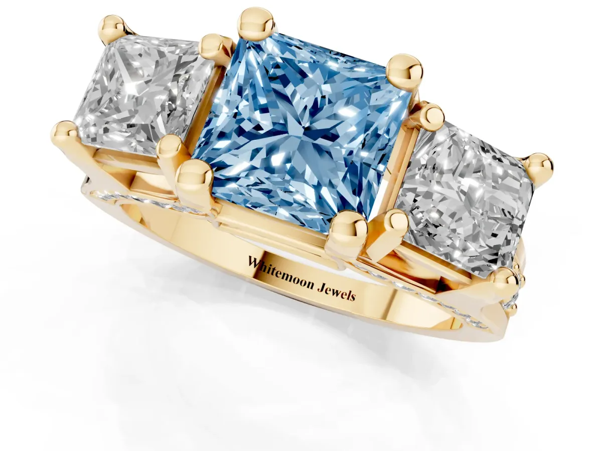 Fancy Blue Princess Cut Diamond Three-Stone Ring with Channel Set Band and Four-Prong Setting Yellow gold