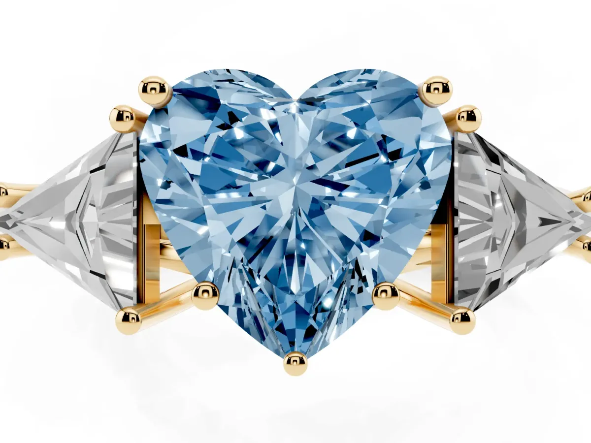 Fancy Blue Three-Stone Heart Cut Diamond Engagement Ring with Trillion Side Stones and Prong Setting Yellow gold