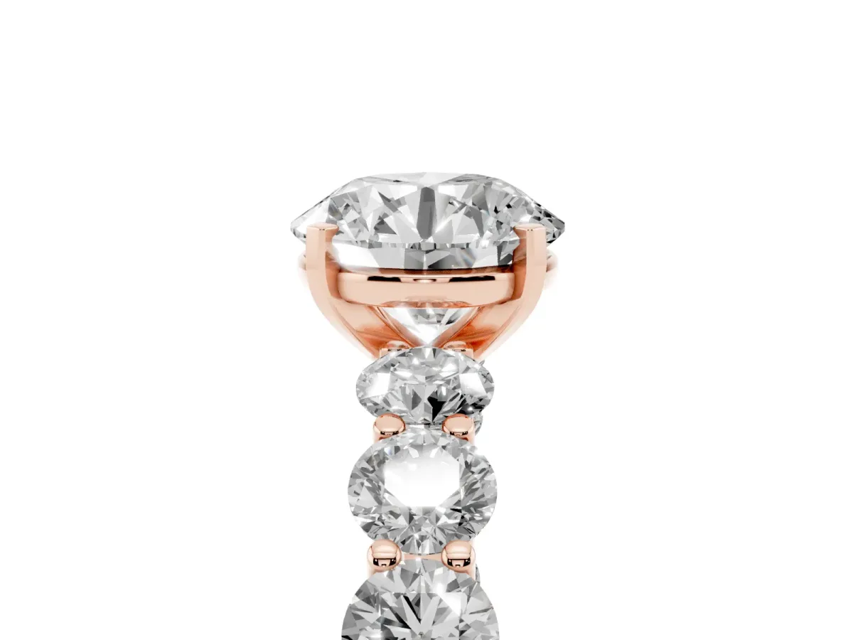 Round Cut Diamond Prong Setting with Side Stones on a Pave Band Rose gold
