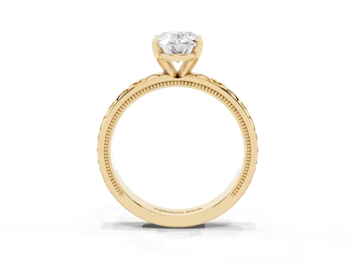Oval Cut Solitaire Diamond Engagement Ring with XO Engraved Band and Four-Prong Setting Yellow gold